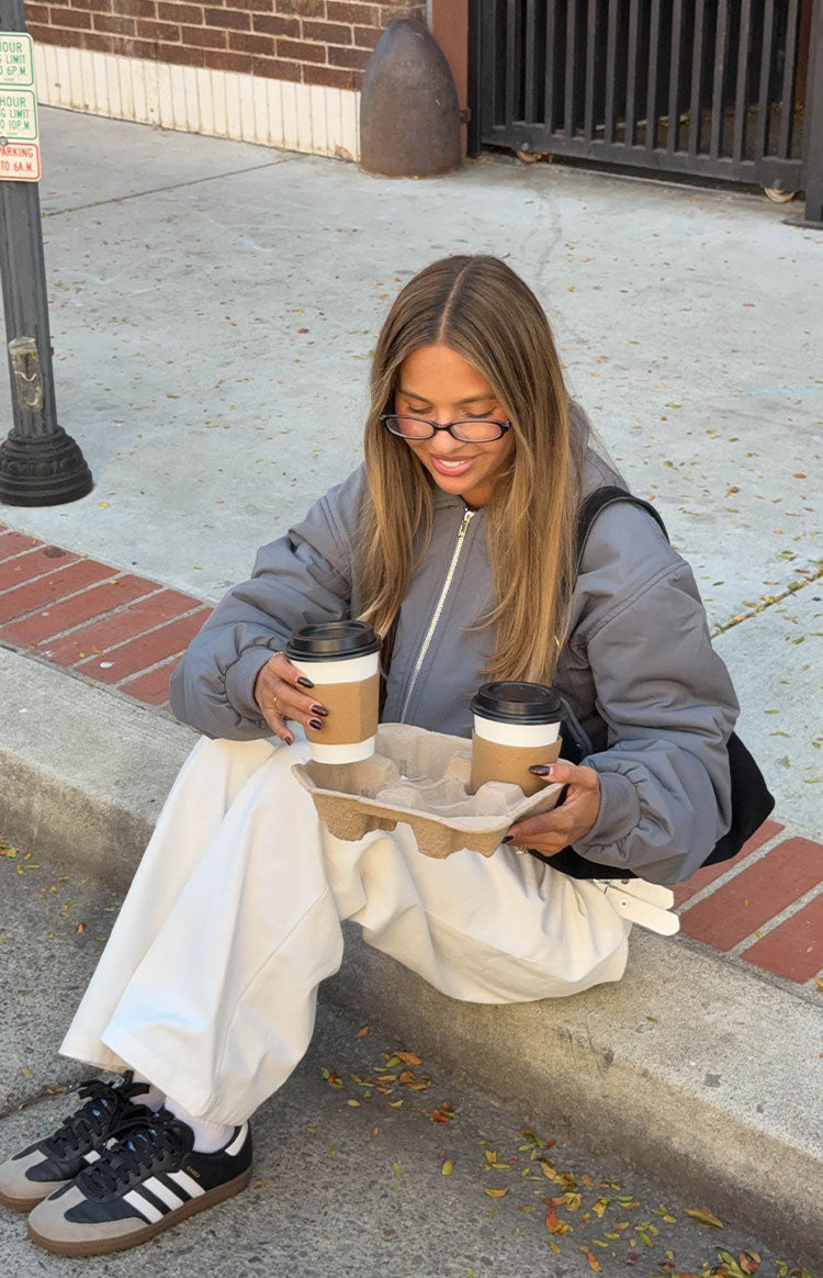 Grey puff bomber jacket with a relaxed fit and full silver zip front