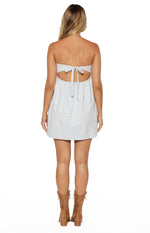 Rear view of a blue and white gingham strapless mini dress with a tie-back and cut-out detail
