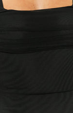 Close-up of the black mesh fabric with horizontal ruched detailing on the bodice of the maxi dress