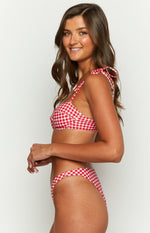 Side view of red gingham bikini bottoms with a high-cut leg and narrow hip band