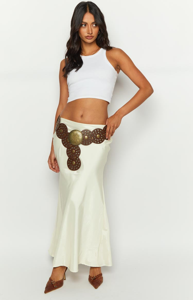 Full length view of a cream satin maxi skirt with a flowy bias cut and subtle sheen
