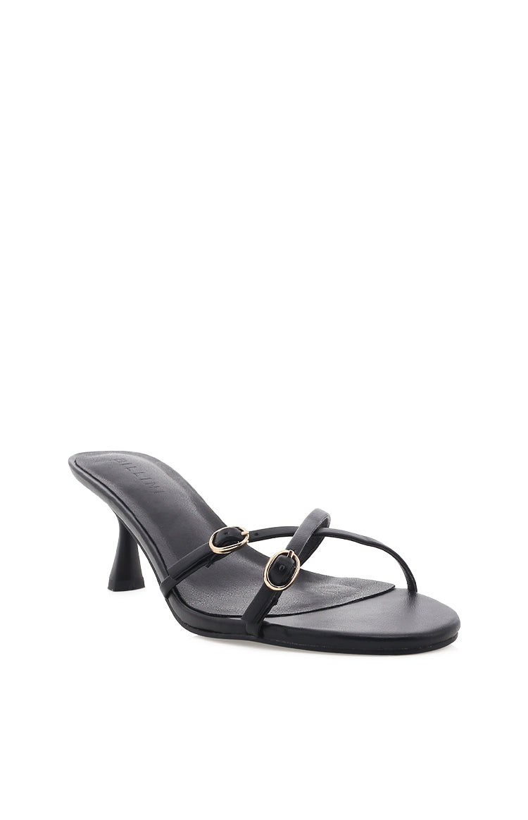 Side view of black heels with thin straps across the foot and two small gold buckle details