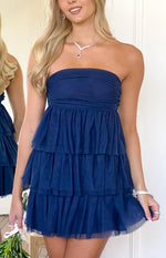 Close-up of the navy strapless mini dress showing the ruched bust and tiered tulle ruffle skirt