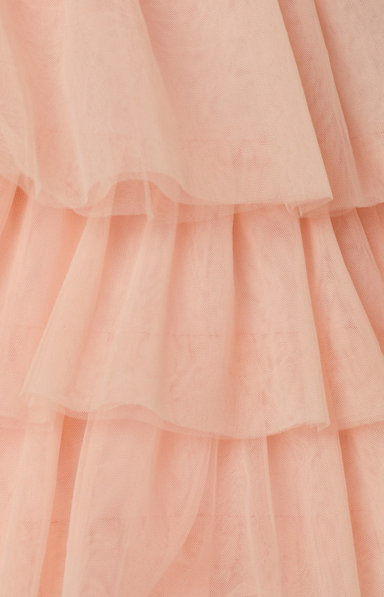 Front view of a pink halter mini dress with a deep V-neck and a layered ruffled skirt