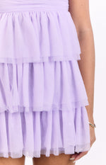 Close-up of the gathered tiered lilac tulle ruffles on the mini dress skirt
