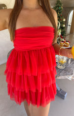 Close-up of the red strapless mini dress showing the ruched bodice and tiered ruffled tulle skirt