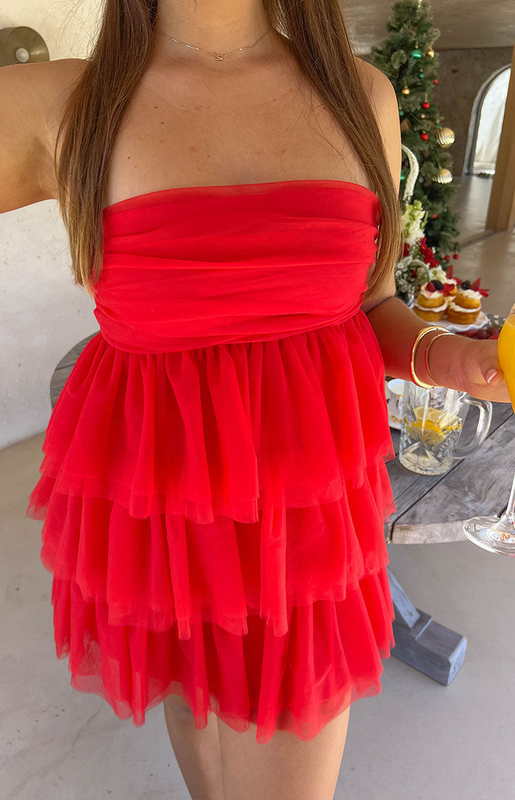 Close-up of the red strapless mini dress showing the ruched bodice and tiered ruffled tulle skirt