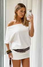 White off-shoulder mini dress with a draped blouson top and fitted mini skirt