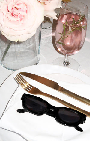 Black slimline sunglasses with chunky rectangular frames and dark tinted lenses