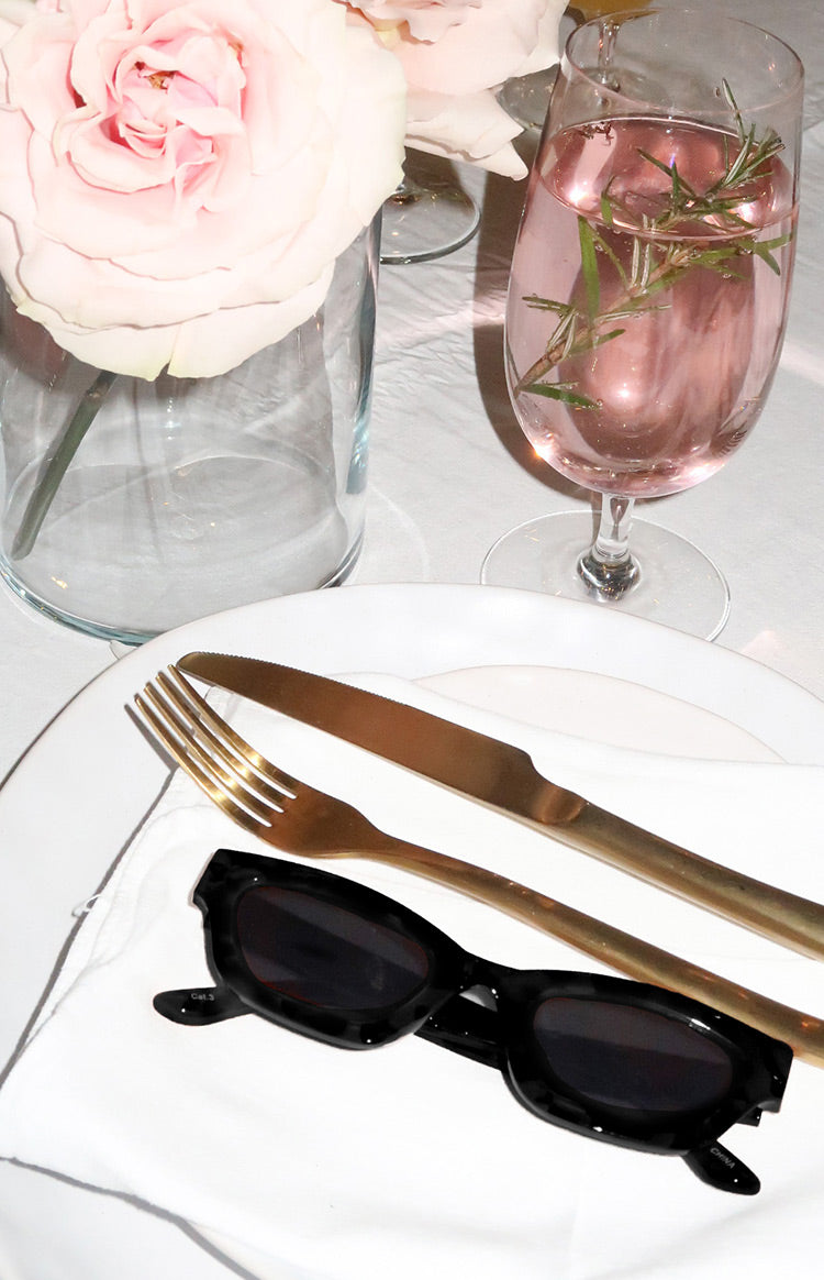 Black slimline sunglasses with chunky rectangular frames and dark tinted lenses