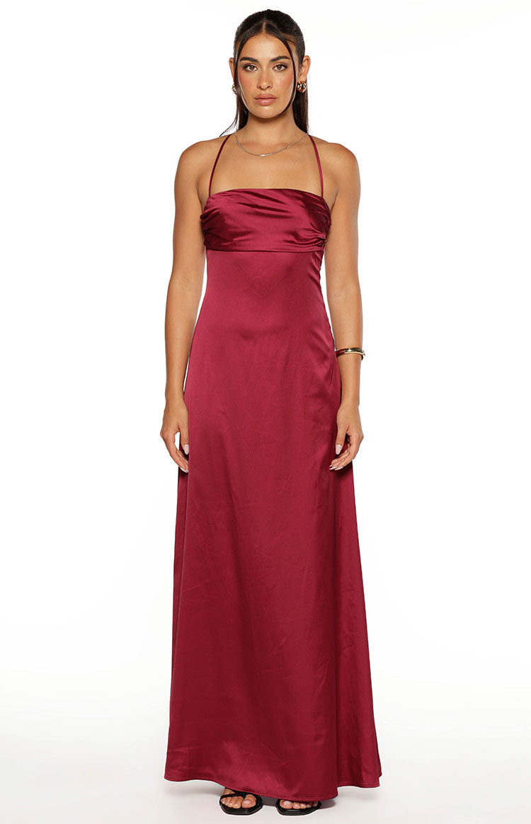 Front view of a burgundy satin maxi dress featuring a gathered strapless neckline with delicate spaghetti straps and a flowing skirt