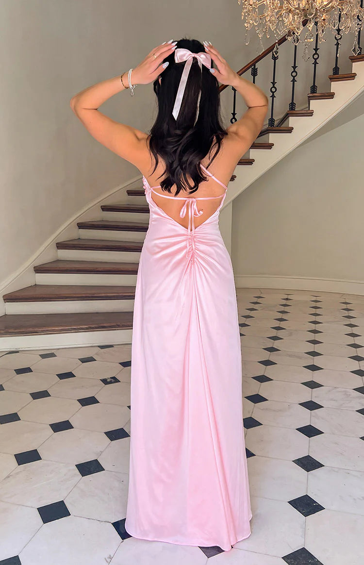 Rear view of a pink satin maxi dress with criss-cross tie-up back straps and ruched detail