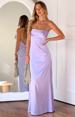 Lilac satin maxi dress with a ruched bust and thin spaghetti straps, with a reflection showing the low scoop back and criss-cross tie detail