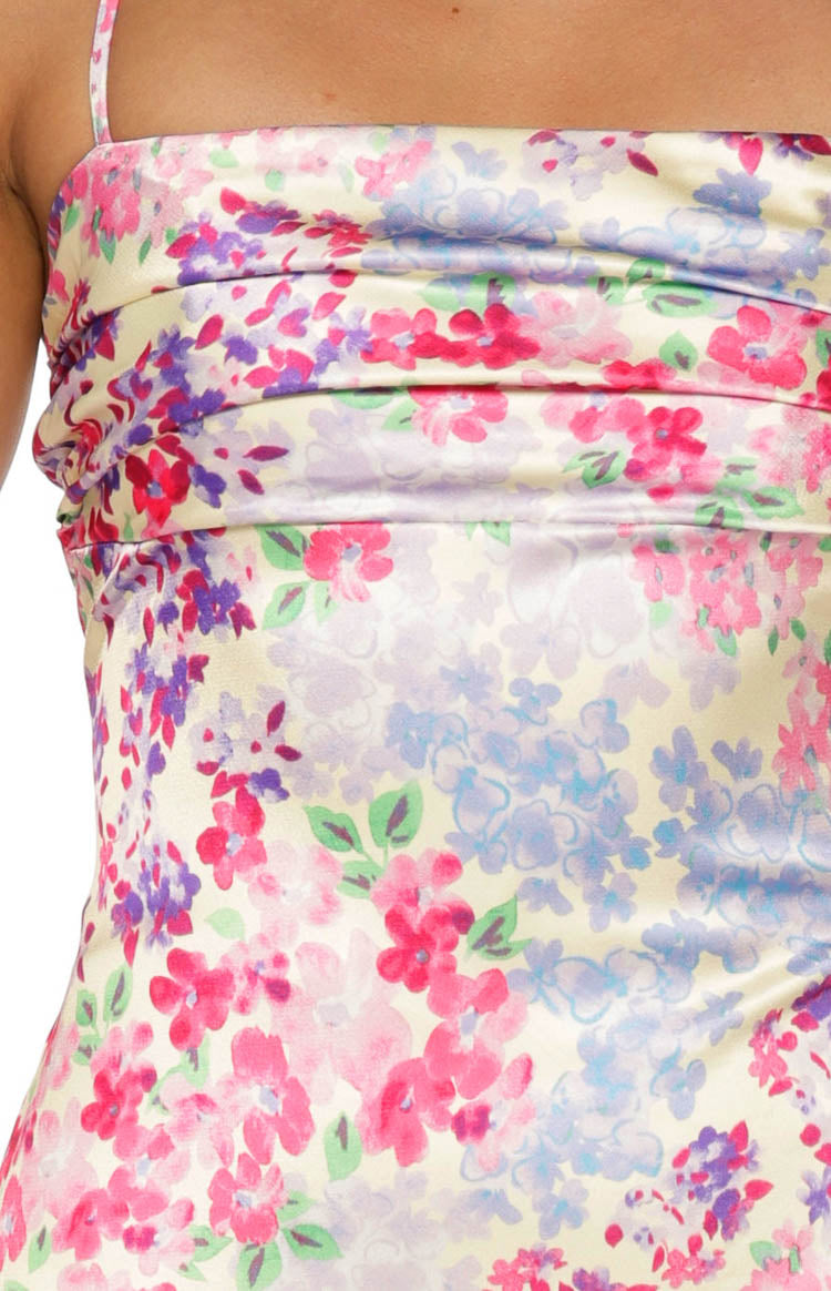 Close-up of the ruched bodice and multi floral pattern on the satin maxi dress