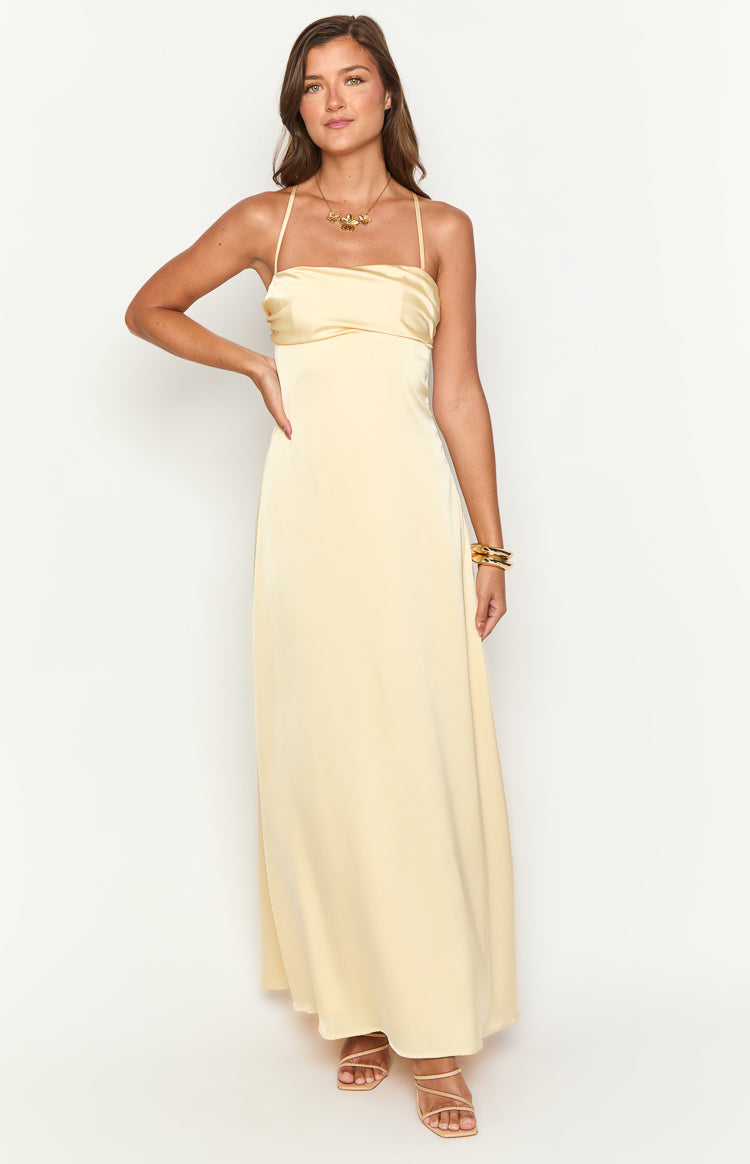 Yellow satin maxi dress with a straight neckline, gathered bust, and thin spaghetti straps