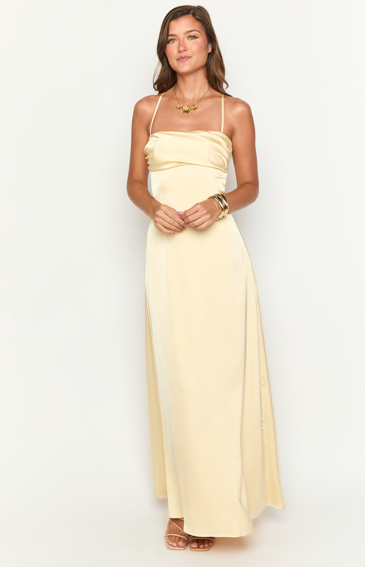 Front view of a yellow satin maxi dress with a draped straight neckline and thin spaghetti straps