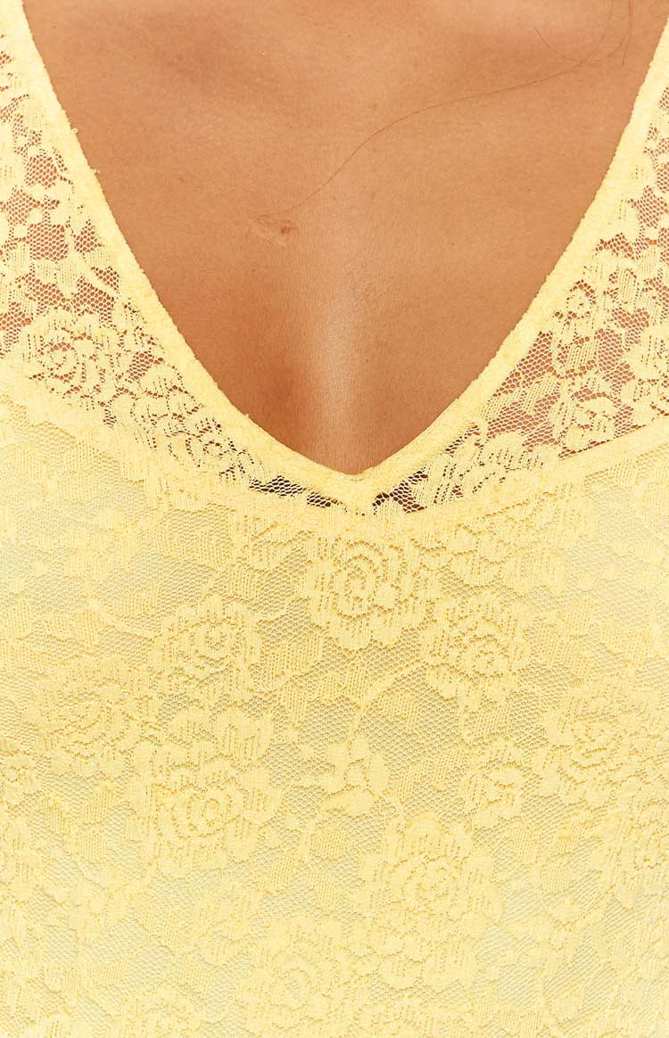 Full front view of a yellow floral lace maxi dress with a V-neckline and ruffled cap sleeves, fitted silhouette
