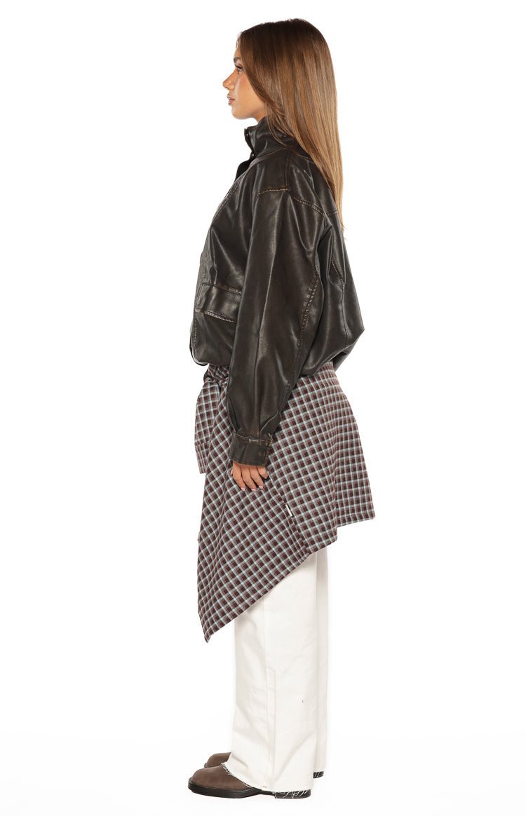 Side view of a brown PU funnel neck jacket with a relaxed fit, long sleeves, and chest pocket