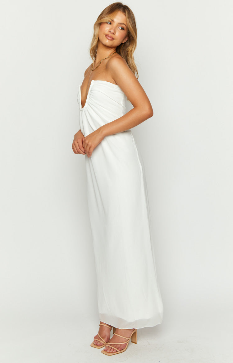 Side view of a white strapless maxi dress with a deep V-neckline and ruched bust detail