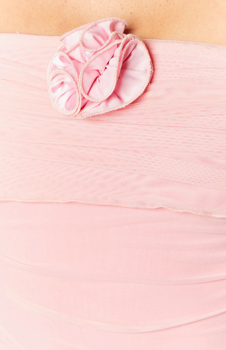 Close-up of a pink floral appliqué detail on the ruched pink mesh mini dress