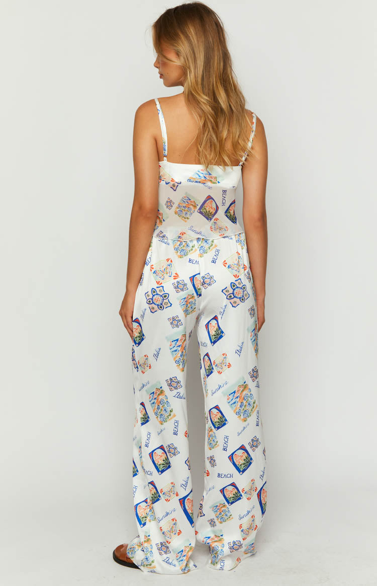 Rear view of white satin wide-leg pants with a colourful Italia print and a flat back waist