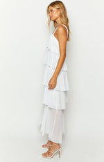 Side view of a white tiered maxi dress with spaghetti straps and a sheer bottom layer