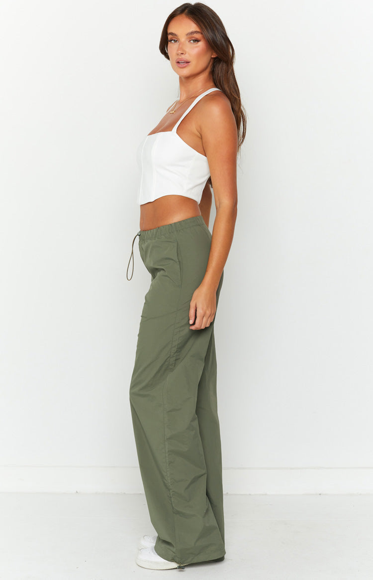 Side view of khaki wide-leg cargo pants showing drawstring waist, side pockets, ruched leg, and ankle zippers