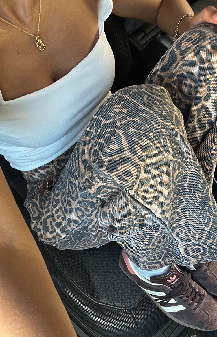 Close-up of the textured brunet leopard print denim jeans, showing the fabric weave