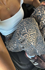 Close-up of the textured brunet leopard print denim jeans, showing the fabric weave