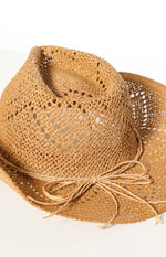 Close-up of the tan open-weave straw western hat with a straw tie band and bow detail