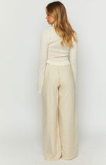 Rear view of cream linen blend wide-leg pants showing the relaxed fit and subtle texture of the fabric