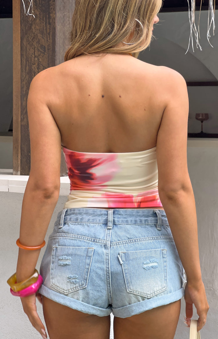 Rear view of a fitted yellow and pink floral print strapless tube top with a straight back neckline