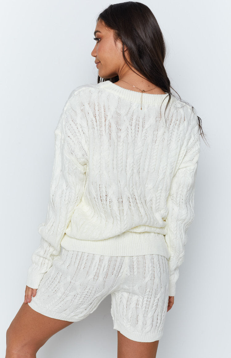 Cream cable knit long sleeve sweater and shorts set, showcasing intricate open knit patterns from the back
