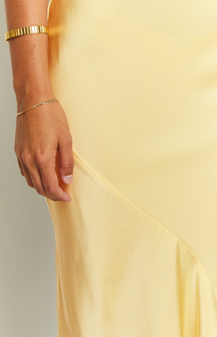 Front view of the carnation yellow satin maxi dress, showing the scoop neckline, thick shoulder straps, and subtle side ruching