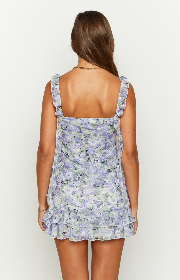 Close-up of the purple and green floral print chiffon fabric with subtle texture and tiered ruffles