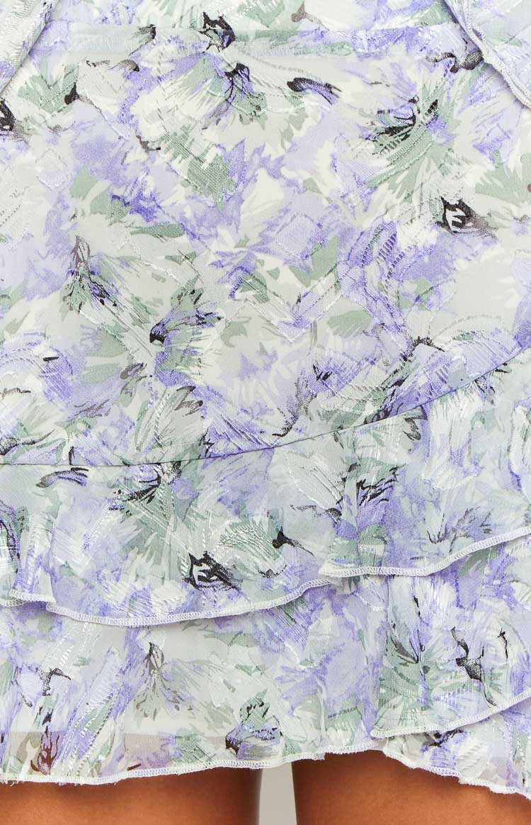 Rear view of the purple floral chiffon mini skirt with ruffled tiers and side tie details