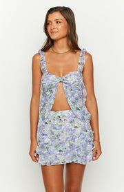 Purple floral chiffon top featuring a square neckline, ruffled straps, and a central cutout with a tie front