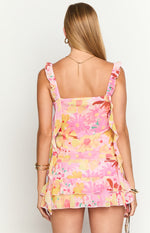 Rear view of the tiered ruffled hem and colourful floral print of a chiffon mini skirt