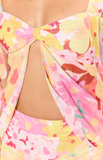 Close-up of the knotted bust and central cutout detail of a pink and yellow floral top