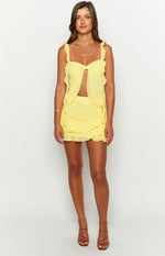 Full front view of a bright yellow chiffon mini skirt featuring a fitted waist and two ruffled tiers