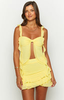 Beginning Boutique Caspian Yellow Chiffon Top yellow chiffon top with a bow front, cutout, ruffled straps, and a layered ruffled hem