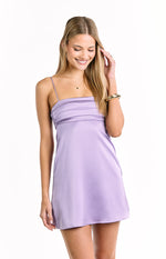 Front view of a lilac mini dress with a square neckline, thin spaghetti straps, and pleated bust