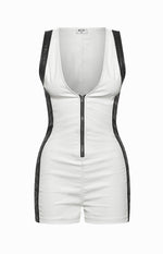 Fitted white sleeveless playsuit with black contrast side panels, a deep V-neck, and full-length front zipper