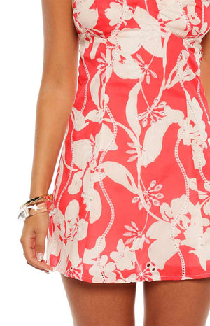 Model in the Chapman Red Floral Mini Dress with puff sleeves and a square neckline. A romantic and feminine choice for a picnic or a casual summer date.