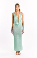 The back view of a light green knitted maxi-dress- showcasing an open back with a tied halter neckline and two horizontal straps across the lower back.