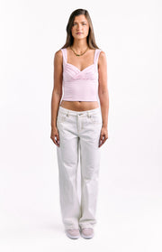 Full length front view of white low waist baggy leg jeans showing the relaxed fit and contrast stitching