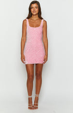 Pink mini dress covered in small, shimmering sequins, featuring a square neckline