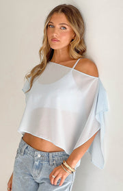 Light blue sheer chiffon cape with an off-shoulder neckline, wide open sleeves, and a cropped raw hem