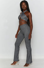 Black shimmery ribbed knit pants with a high V-waist and a subtle flare leg