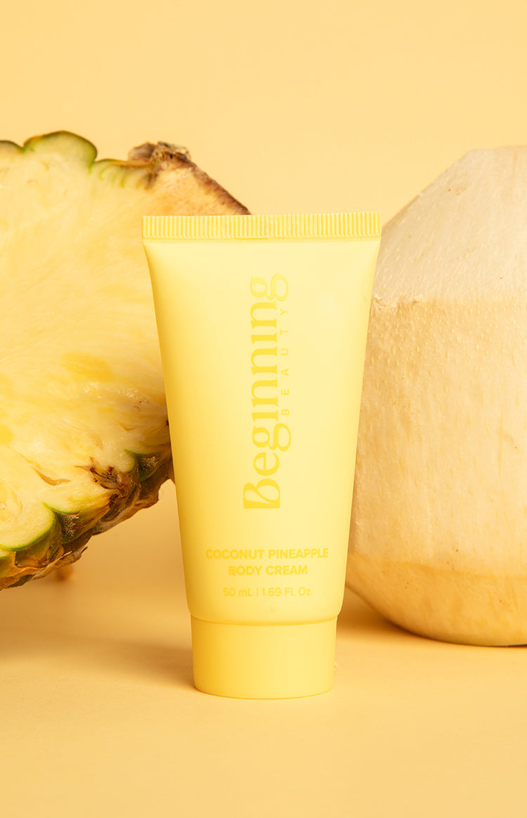 Yellow body cream tube with Coconut Pineapple Body Cream 50 mL text